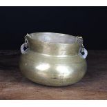 A Turned Bronze Hanging Pot with suspension chains threaded through silhouette cut lugs either side,