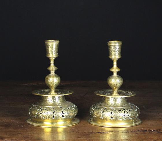 A Pair of 19th Century Engraved Brass Candlesticks with pierced truncated bell form bases