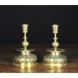 A Pair of 19th Century Engraved Brass Candlesticks with pierced truncated bell form bases