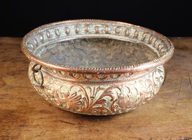 A 17th Century Copper Repoussé Bowl embossed and chased with birds & beasts amongst scrolls of