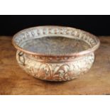 A 17th Century Copper Repoussé Bowl embossed and chased with birds & beasts amongst scrolls of