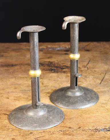 A Pair of 19th Century Brass-Banded Iron Hog-scraper Candlesticks, 9 in (23 cm) in height.