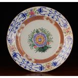 A Large Chinese Plate centred by an enamelled chrysanthemum bloom and sprays of foliage,