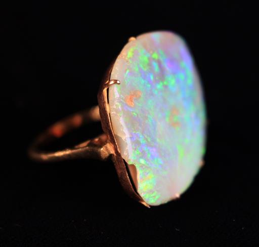 A Gold Ring set with a large uncut Opal stone.