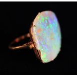 A Gold Ring set with a large uncut Opal stone.