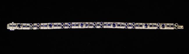 An Art Deco 18 Carat White Gold Bracelet set with round and square cut sapphires edged in diamonds.