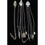 Three Steel Chatelaines with pierced steel belt clips;