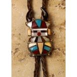 A Vintage Zuni "Antelope Kachina" Bolo, having brown shell "horns" and inlaid with coral,