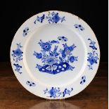 An 18th Century Blue & White Delft Charger decorated with floral sprays and moths,