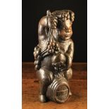 An 18th Century Naively Carved Oak Figure of a Bacchanalian Putto wreathed in fruiting vine,