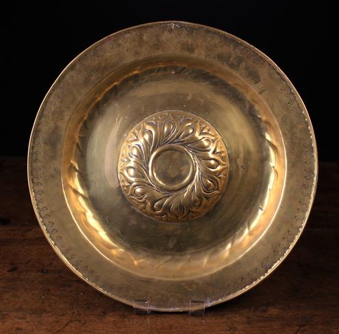 A Large 16th Century Nuremberg Brass Repoussé Alms Dish having a gadrooned boss to the centre and