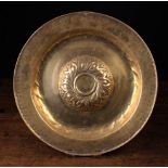 A Large 16th Century Nuremberg Brass Repoussé Alms Dish having a gadrooned boss to the centre and