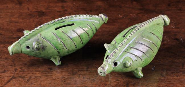 Two Mid 19th Century Green-Glazed Country Pottery Pig Money Boxes.