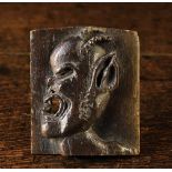 A Small 16th Century Carved English Panel displaying a horned devil in profile. Approx. 4¼ ins (10.