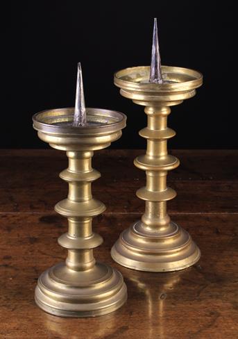 Two Similar 16th Century Pricket/Candlesticks with three blade knopped cylindrical stems on round