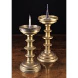 Two Similar 16th Century Pricket/Candlesticks with three blade knopped cylindrical stems on round