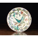 A Mid 17th Century Turkish Iznik Pottery Plate decorated with a bird in profile. Approx.