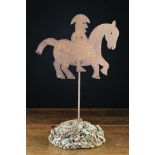 An Antique Sheet Iron Silhouette Cut Horse & Rider Weather vane mounted on a section of tree burr,