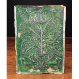 An 18th Century German or Dutch Green Glazed Terracotta Stove Tile moulded with an urn of tulips