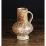 A Late 16th/Early 17th Century Saltglazed Stoneware Jug having a cylindrical neck above a bulbous