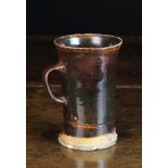 An Early 19th Century Treacle Glazed Stoneware Frog Mug, 5¾ in (14.5 cm) in height.