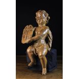 A 17th Century Flemish Carved Cherub Holding a Monogrammed Shield. Approx.