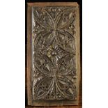 An Early 16th Century Dark Oak Panel carved with Gothic tracery, 16¾ in x 8½ in (42.5 cms x 21.