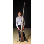 A Very Large Wooden Rifle for Shop Display Purposes, 96 in (244 cm) in length.