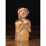 A Primitive Carved Elm Bust of a Female, holding a ring in her hands, 18th/19th Century, 7¼ in (18.