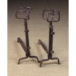 A Pair of 18th Century Wrought Iron Cresset-topped Fire Dogs with adjustable spit hooks to the