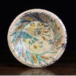 A Sgrafitto Pottery Bowl decorated with a bird framed by a border of wrythen leaves,