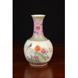 A Chinese Republic Bottle Vase (A/F) enamelled with flowers (hole to base) 11 in (28 cm) in height.
