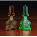 A Pair of Art Deco Moulded & Etched Glass Scent Bottles; one green, the other amber,
