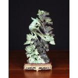 A Fabulous Oriental Bi-colour Jade-like Carving of a scrolling dragon and Fenghuang stood on a