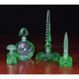 A Group of Four Art Deco Green Glass Scent Bottles ranging from 8 in (20 cm) to 2¾ in (7 cm) in