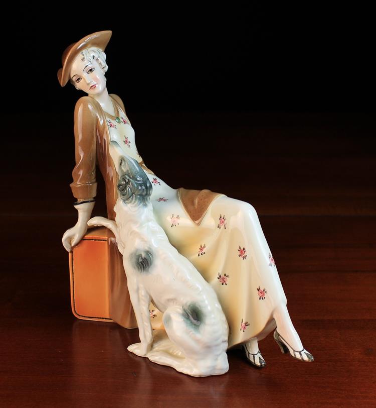 A Katzhütte Porcelain Art Deco Style Figure of an elegant lady reclining on a pedestal with a