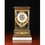 A Fine French Mantel Clock with bevelled glass sides in a gilt metal frame adorned with sprays of