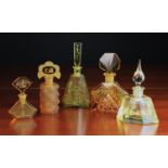 A Group of Five Art Deco Scent Bottles: Three of amber glass 6 in (15 cm),
