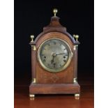 A 19th Century Mahogany Bracket Clock inlaid with brass stringing.
