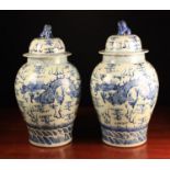 A Pair of Large Chinese Blue and White Temple Jars & Covers decorated with celestial dragons amidst