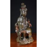 An Antique Lacquered Wood carving of Guanyin sat above a rocky base, 22¾ in (58 cm) high.