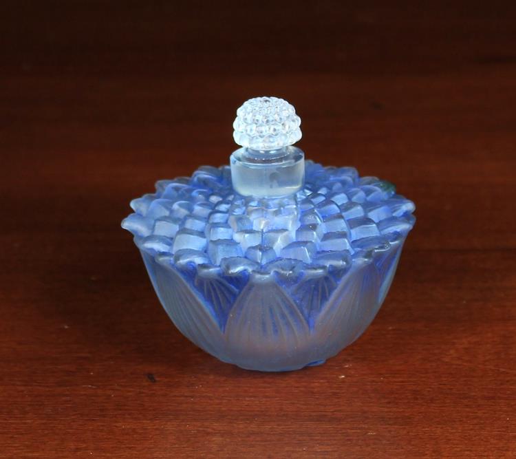 A Lalique Scent Bottle of pale blue tinged frosted glass moulded as a lotus flowerhead with a seed