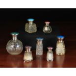 Seven Pretty Cut Glass Scent Bottles with silver & guilloche enamelled lids.