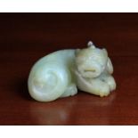 A 19th Century Celadon Jade Carving of a reclining beast, 2 in (5 cm) high, 3¾ in (8.