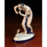 An Art Deco Style Royal Dux Figure of a Semi-Naked Female Snake Charming wearing a dark blue & gilt