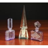 Three Art Deco Scent Bottles: Two of moulded mauve glass 5¼ in (13 cm) and 4¾ in (12 cm) in height.