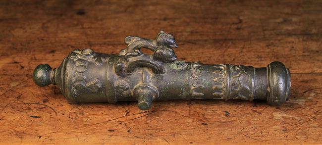 A Rare 17th Century Miniature Bronze Cannon cast with two lions and ornamentation to the barrel,