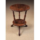 A Small 18th Century Two Tier Cricket Table with circular oak top above a smaller undershef divided