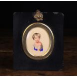 An Early 19th Century Miniature Portrait, painted in watercolours on card with bust of a young boy,