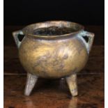 An Antique Bronze Cauldron with triangular lug handles (A/F), 6¼ ins (16 cms) in height.